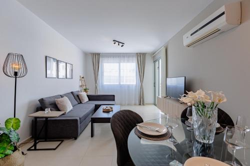 a living room with a couch and a table at Stylish One-Bedroom Sea Retreat in Paralimni