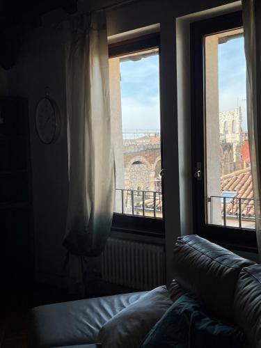 a room with a couch and a window with a view at SWEETHOME ARENA VIEW - con parcheggio in Verona