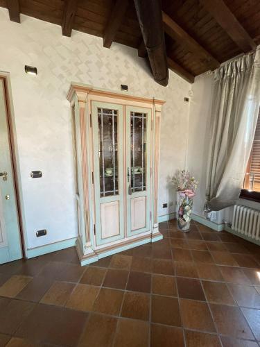 a large wooden cabinet in a room with a window at SWEETHOME ARENA VIEW - con parcheggio in Verona