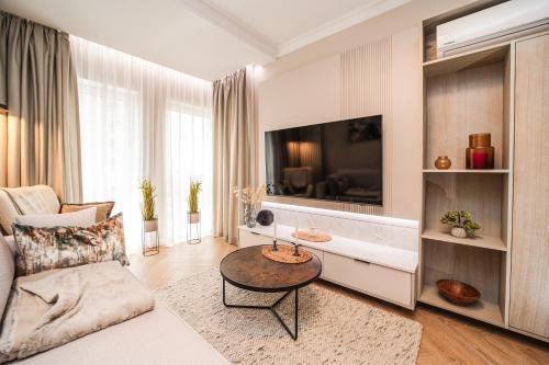 a living room with a couch and a table at Initium Apartamenty in Puck