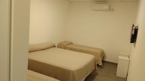Postel nebo postele na pokoji v ubytování HOTEL ARANDÚ
