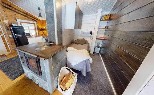 a kitchen with a wood stove in a room at Levin Rankis in Kittilä