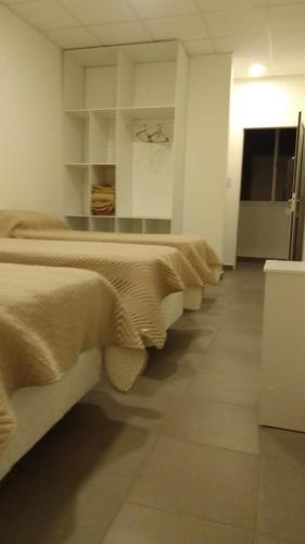 a row of beds sitting in a room at HOTEL ARANDÚ in Villaguay