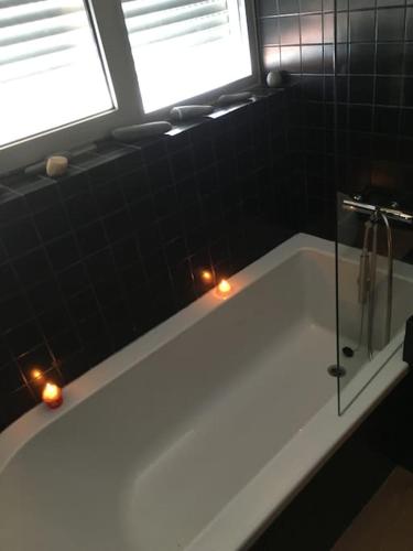 a bathroom with a bath tub with two windows at Caminho de Santiago, Alandroal in Alandroal
