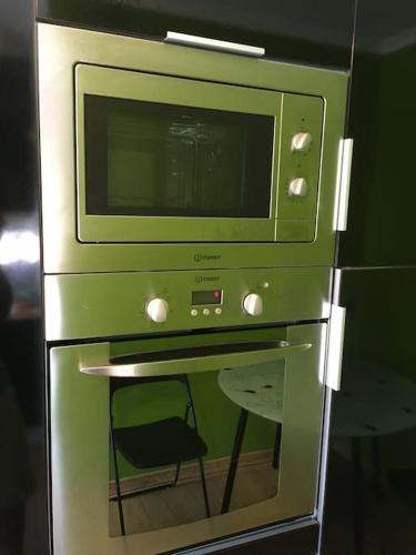 a microwave oven with a chair inside of it at Caminho de Santiago, Alandroal in Alandroal