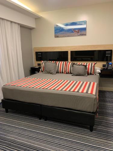 a bedroom with a large bed in a room at Benjamín I in San Salvador de Jujuy