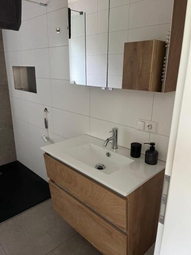 a bathroom with a sink and a mirror at Apartment Ida in Viereth-Trunstadt