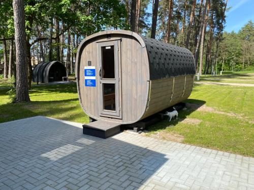 a tiny house on display in a park at Alytaus Kempingas in Alytus