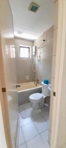 a bathroom with a toilet and a tub and a sink at La Maison transient house in Calapan