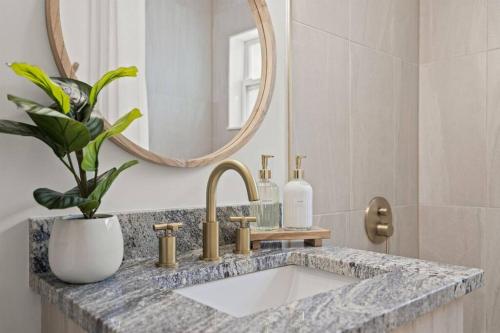 a bathroom with a sink and a mirror at Casa Isla Retreat - near Anna Maria Island in Bradenton
