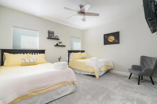 a bedroom with two beds and a ceiling fan at Launch Pad- A Birdy Vacation Rental in Helotes