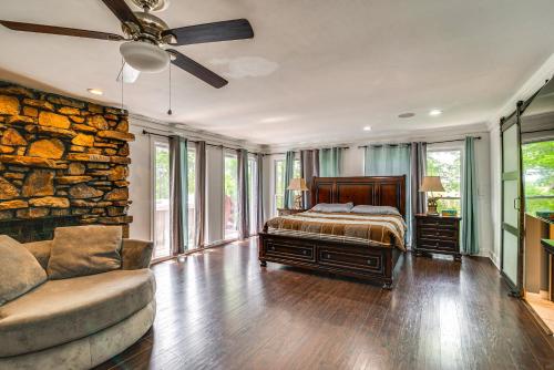 a bedroom with a bed and a stone wall at Spacious Bowling Green Home with Hot Tub and Pool! in Bowling Green