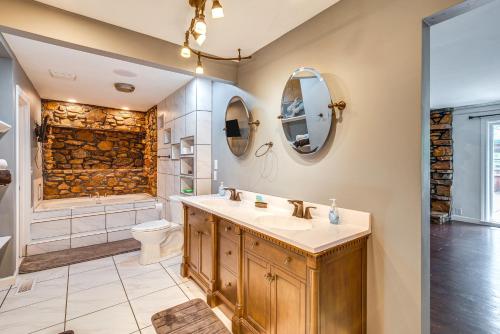 a bathroom with a sink and a toilet and a shower at Spacious Bowling Green Home with Hot Tub and Pool! in Bowling Green