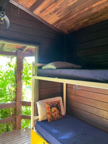 a room with two bunk beds in a house at Vibe House Hostel in Florianópolis