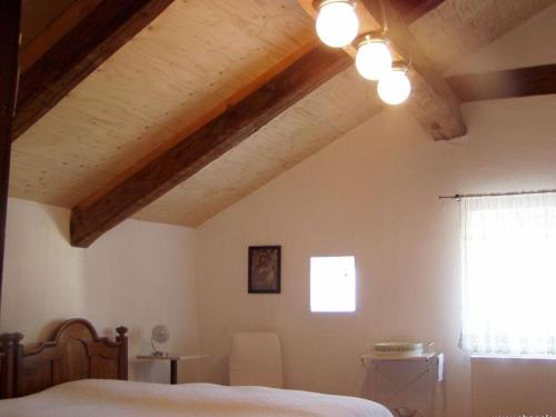 - une chambre avec un lit et un plafond aux poutres apparentes dans l'établissement "Zum Kirchenschuster", à Schernfeld