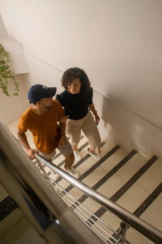 a man and a woman walking down stairs at Hotel Central in Sincelejo