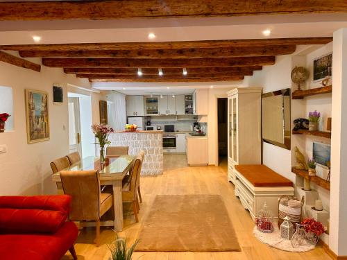 a living room with a dining room table and a kitchen at Holiday Home Nautica in Kotor