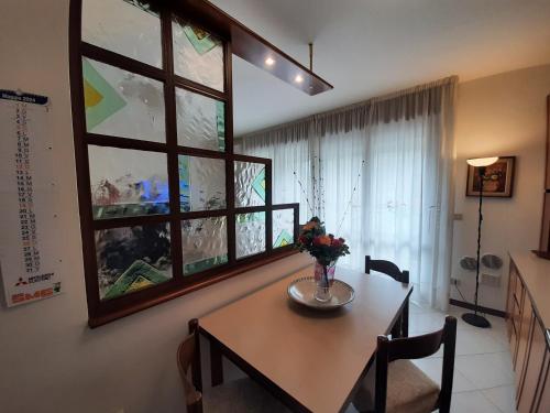 a dining room with a table and a window at CASA DI IANA in Mestre