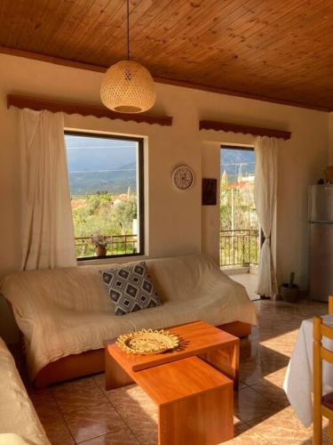 a living room with a couch and a large window at Sparrow’s house in Proástion