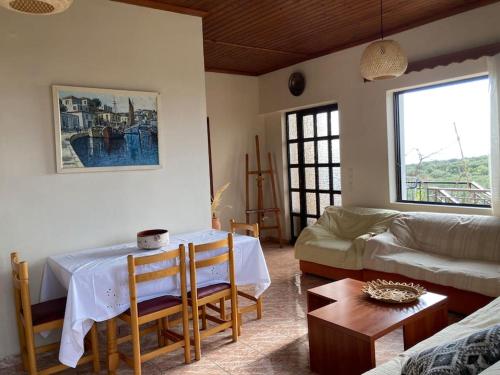 a living room with a table and a couch at Sparrow’s house in Proástion