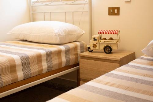 a bedroom with two beds and a toy van on a night stand at Una rosa sul mare Monopoli in Monopoli
