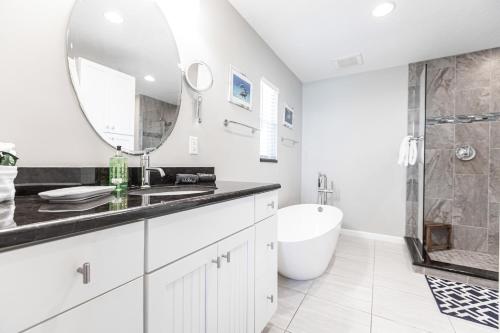 a white bathroom with a sink and a mirror at Siesta Key Island Rentals in Siesta Key