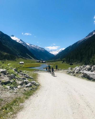 a group of people riding bikes down a dirt road at Apartment Kerer in Wald im Pinzgau