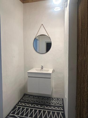 łazienka z umywalką i lustrem na ścianie w obiekcie Monte da Alameda w mieście Santa Luzia
