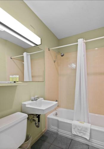 a bathroom with a sink and a toilet and a shower at Holiday Lodge in Wenatchee