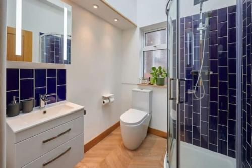 a bathroom with a toilet and a glass shower at Home away from home in Liverpool