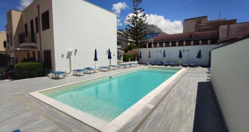 a swimming pool in front of a building at Appartamento LG in San Vito lo Capo