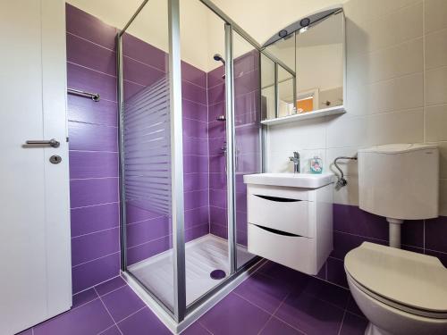 ein lila Badezimmer mit einem WC und einer Dusche in der Unterkunft Juli No1 in Poreč