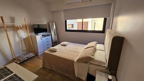 a small bedroom with a bed and a window at Sancer House Bs As in Buenos Aires
