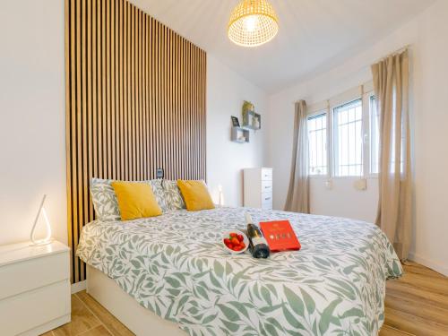 a bedroom with a bed with a book on it at Apartment on Beach Mijas in Mijas Costa