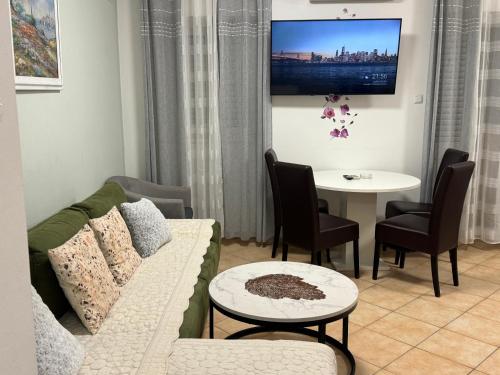 a living room with a couch and a table at Apartment Piko in Crikvenica