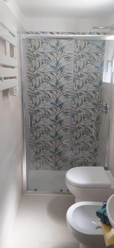 a bathroom with a shower with a toilet and a sink at La casa di Ge e Fra in Galatone