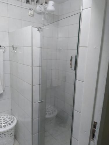 a bathroom with a glass shower with a toilet at Pousada Suítes Meireles in Fortaleza