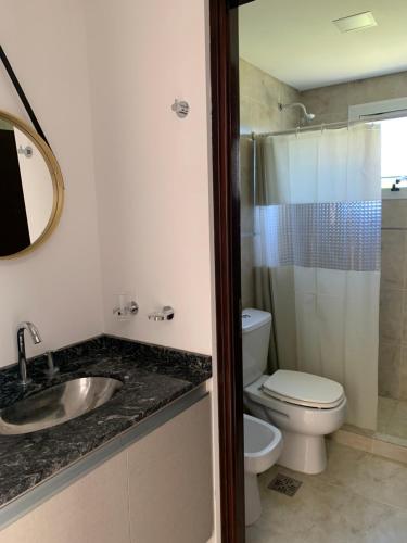 a bathroom with a toilet and a sink and a shower at Veneto Village J in Cordoba