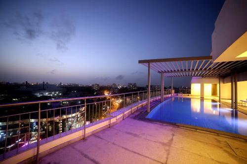 a swimming pool on top of a building at night at Olive Downtown in Cochin
