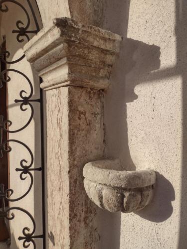 a stone bowl on the side of a building at Appartamenti VERDE ACQUA in Pergine Valsugana