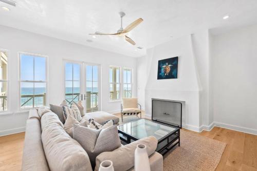 a living room with a couch and a tv at Del Mar in Seacrest