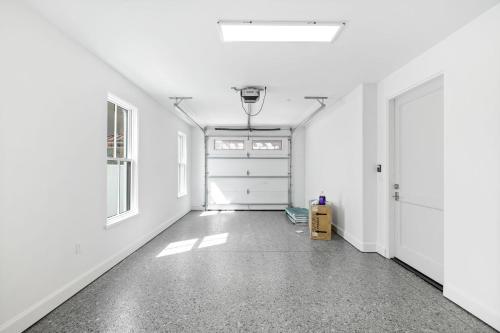 an empty room with white walls and a door at Del Mar in Seacrest
