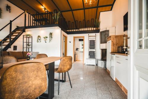 a kitchen and living room with a table and chairs at Black Tiger Seaside - Ferienwohnungen direkt am See in Garden