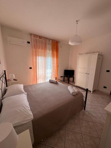 a bedroom with a large bed and a window at Romagnosi apartment in Porto Torres
