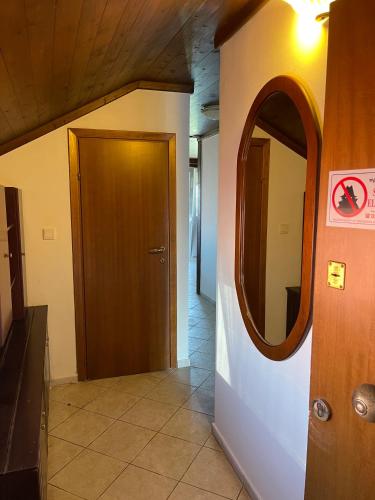 a hallway with a door and a mirror at Indigo sea view rooms in Olympiaki Akti