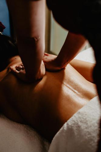 a woman getting a massage on her back at Aroma Stone Hotel Spa in Syców