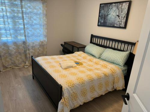 a small bedroom with a bed and a window at Sunset Place in Ottawa