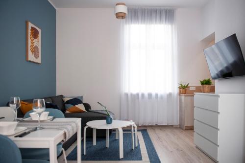 a living room with a couch and a table at Apartamenty Emilia 2 in Gniezno