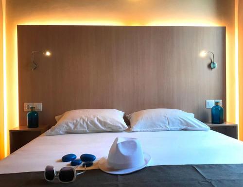 ein Bett mit Hut und Sonnenbrille darauf in der Unterkunft Impressive Platanias Villa Villa Bulma 2 Bedrooms Private Pool in Platanias