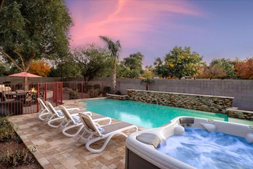 a swimming pool with lounge chairs and a hot tub at Movie Theater Pool Arcade Fire Pit in Glendale